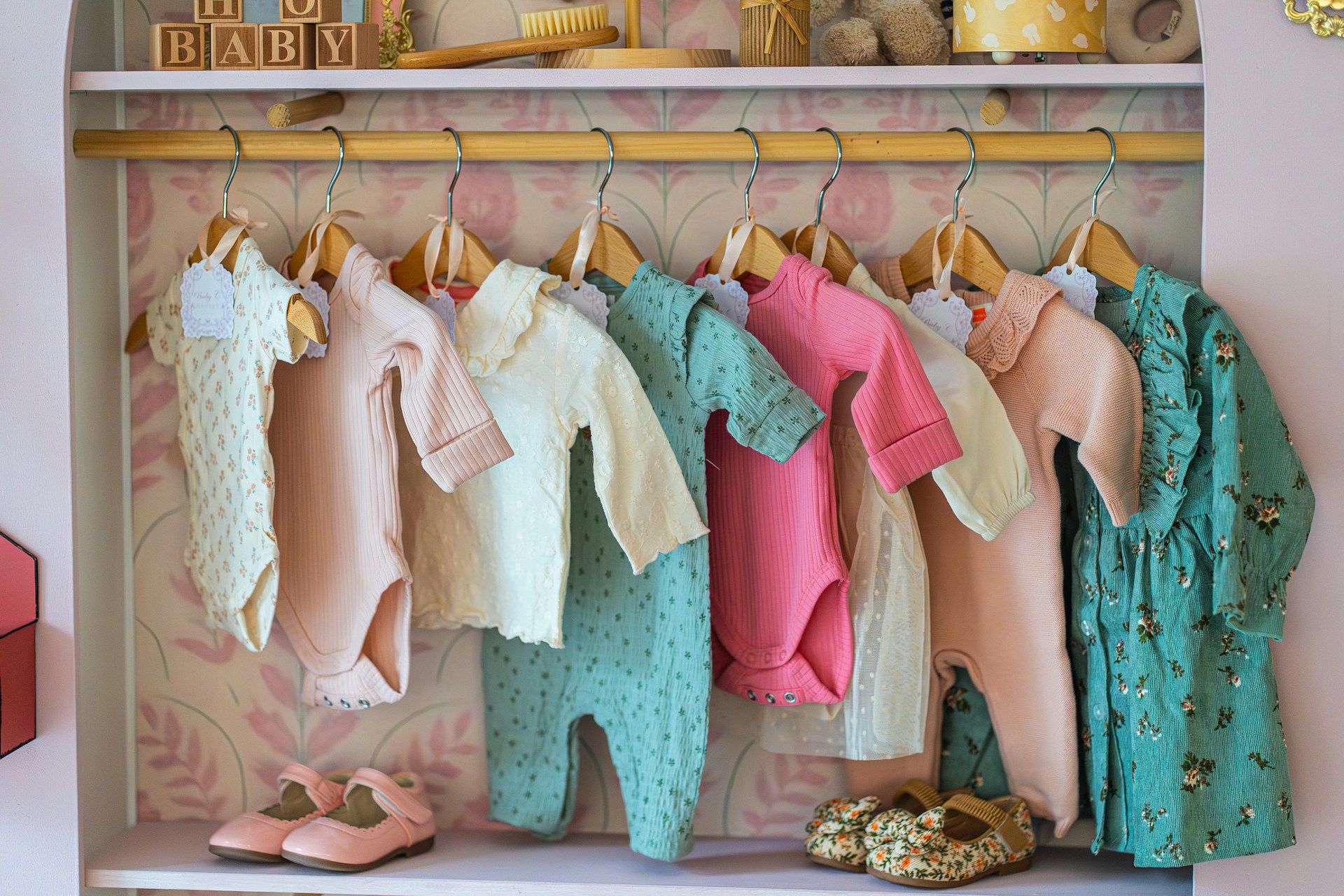 Colourful children's clothing displayed on hangers